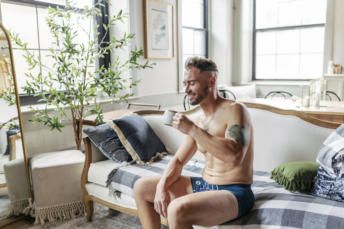 testicle support pouch, man drinking coffee