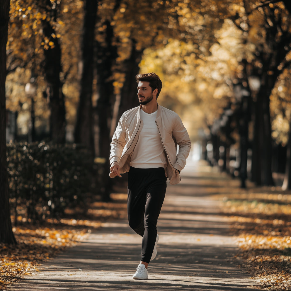 Man walking through a park in fall